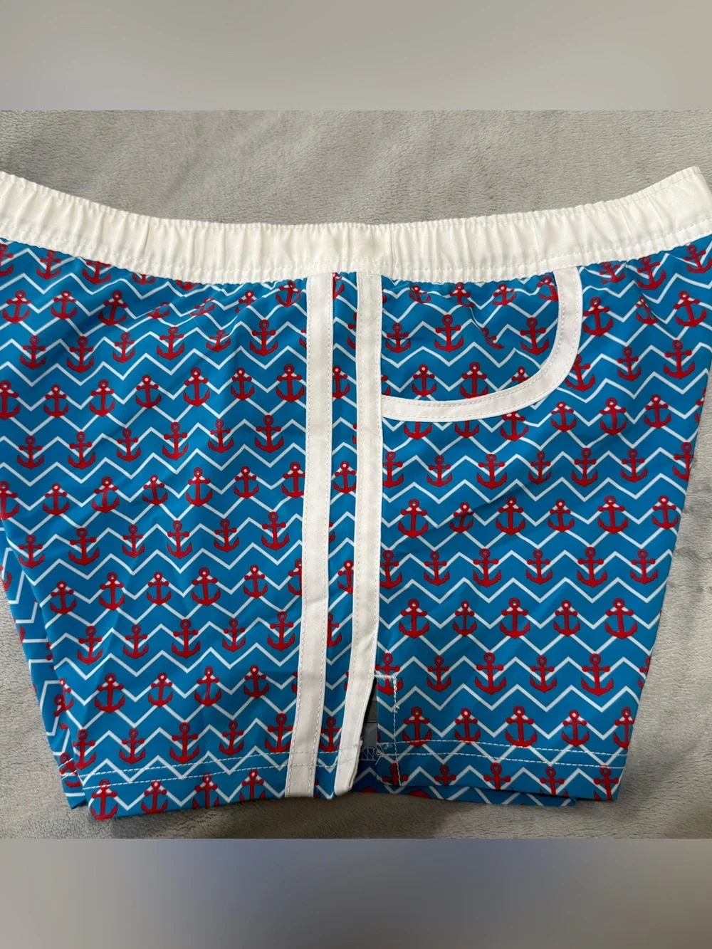 Andrew Christian blue, red and white lined swim trunks. Men’s size medium.